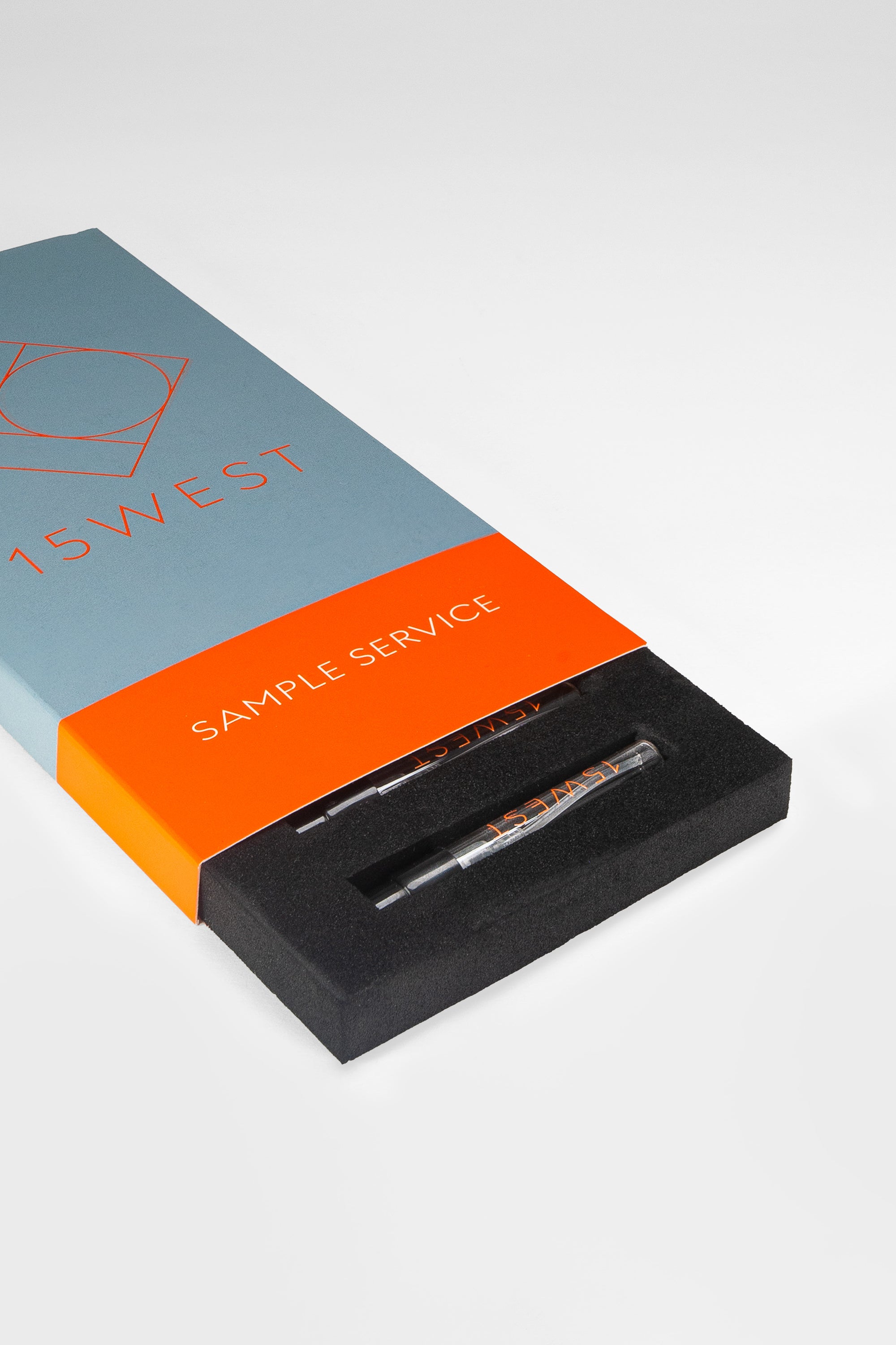 Geöffnete Parfum-Tester-Box von 15West mit blau-orangener Hülle und Logo auf hellem Hintergrund, zeigt zwei Parfumproben in schwarzem Schaumstoff-Inlay